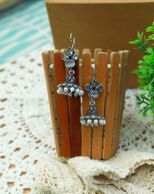 White stone-studded, oxidized silver jhumkas with hanging jhumki bells