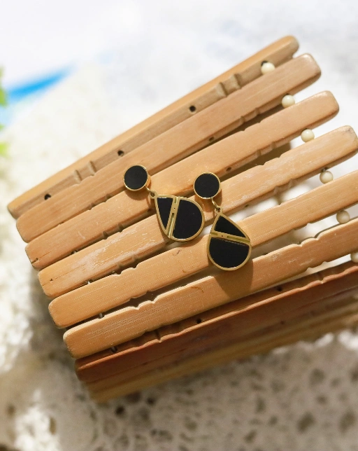 Statement black earrings with a golden outline