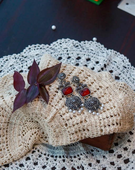Silver-toned oxidized earrings with red stones