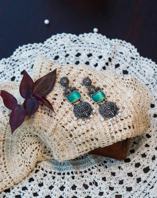 Silver-toned oxidized earrings with mint green stones