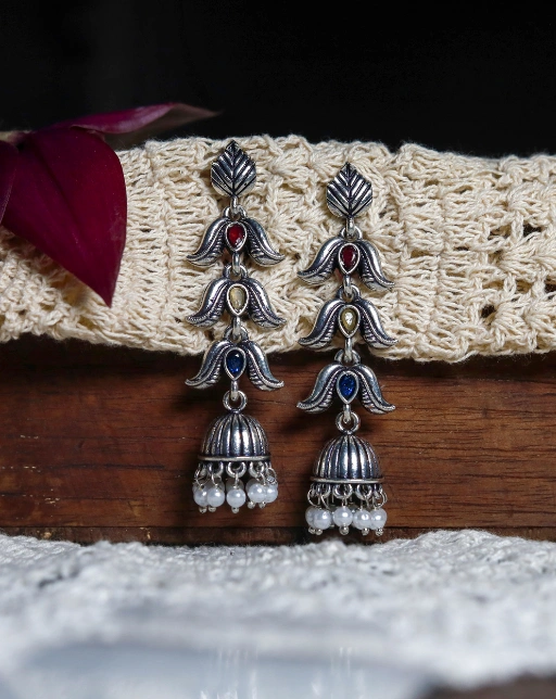 Silver-toned oxidised three tiered jhumka style earrings with multicolour stones